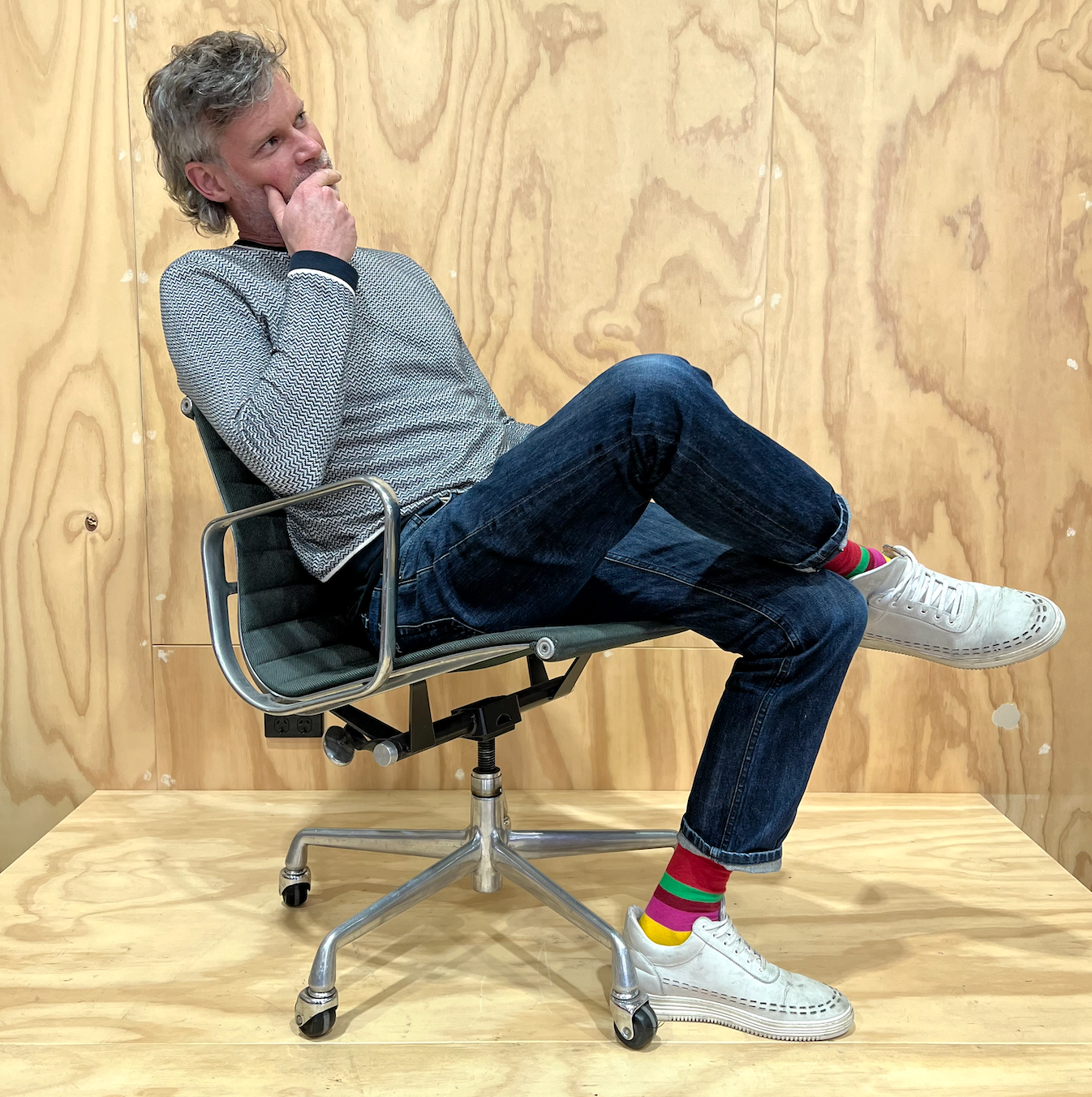 Darren Andrews in the Braybrook showroom sitting on a secondhand office Herman Miller chair
