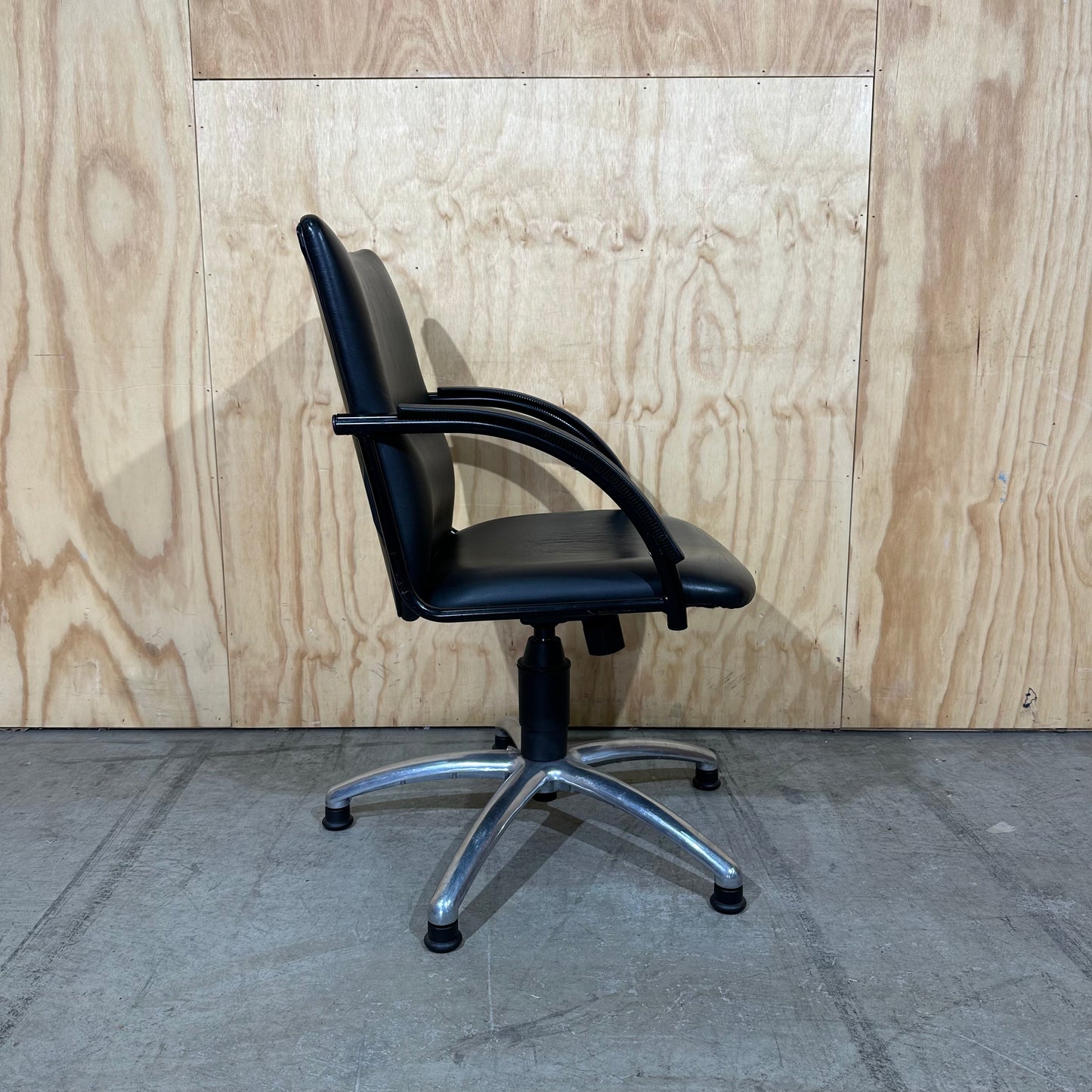 Black faux leather swivel chair on chrome base by Pago