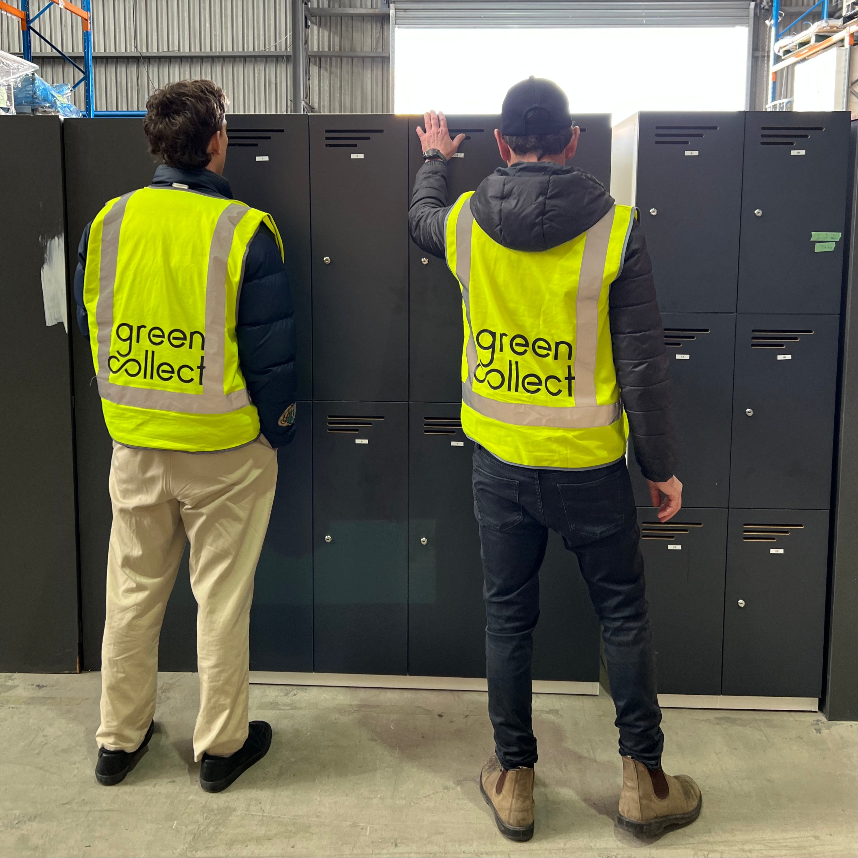 High vis green collect staff reviewing secondhand office furniture for a procurement furniture fitout