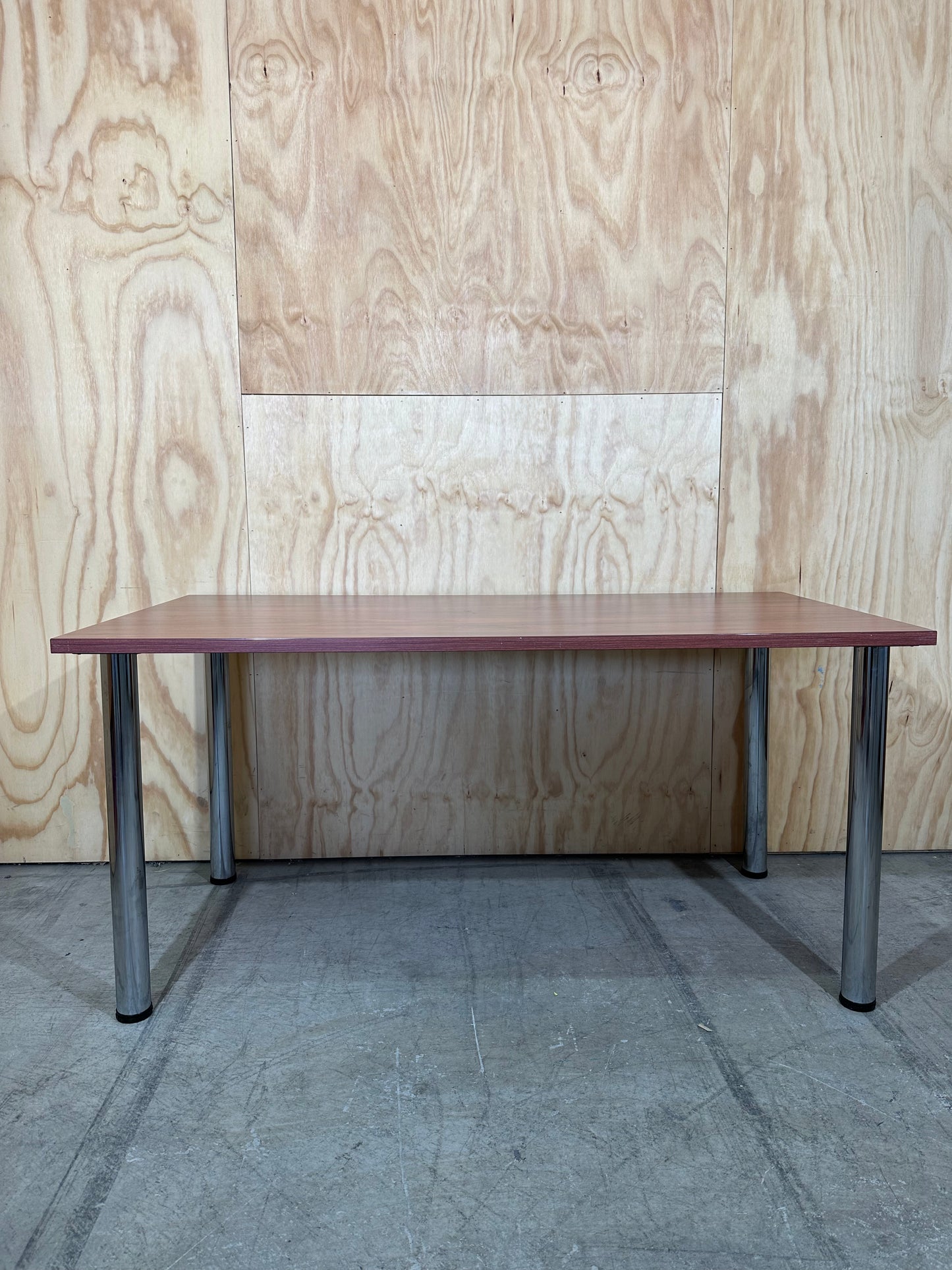 Timber veneered meeting table on chrome legs