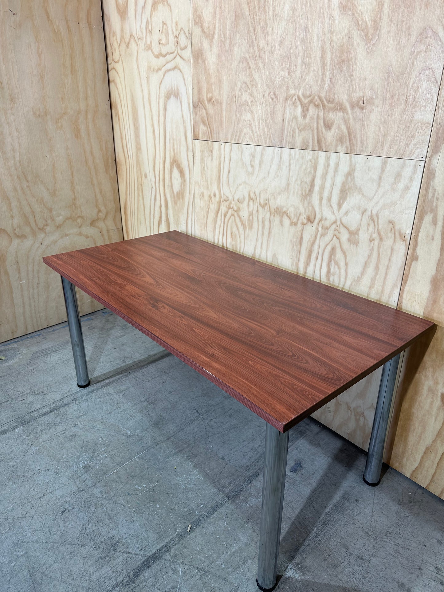 Timber veneered meeting table on chrome legs