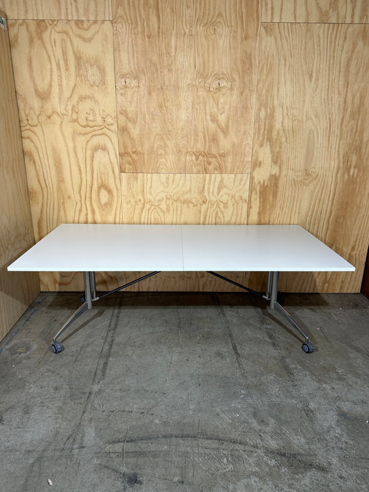 White folding table on castors