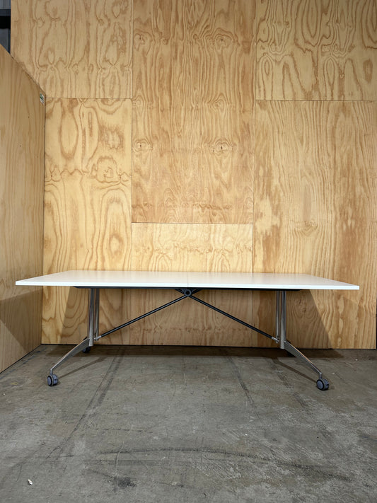 White folding table on castors