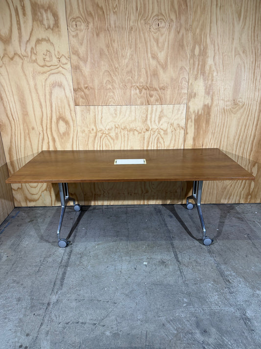 Brown flip table with power box on castors