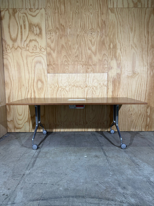 Brown flip table with power box on castors