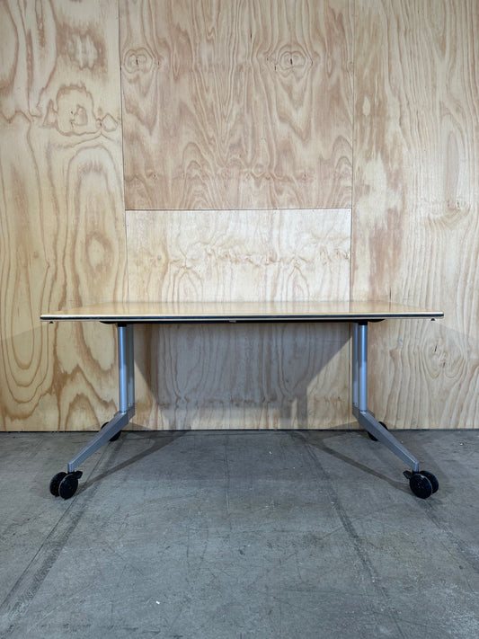 Wilkhahn table with light wood veneer on castors