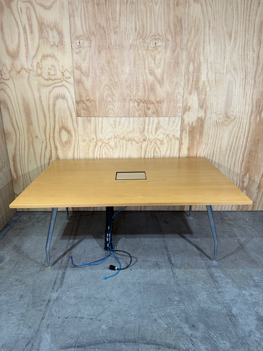Wide wooden meeting table with cable management on chrome legs