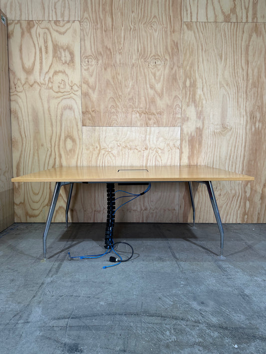 Wide wooden meeting table with cable management on chrome legs