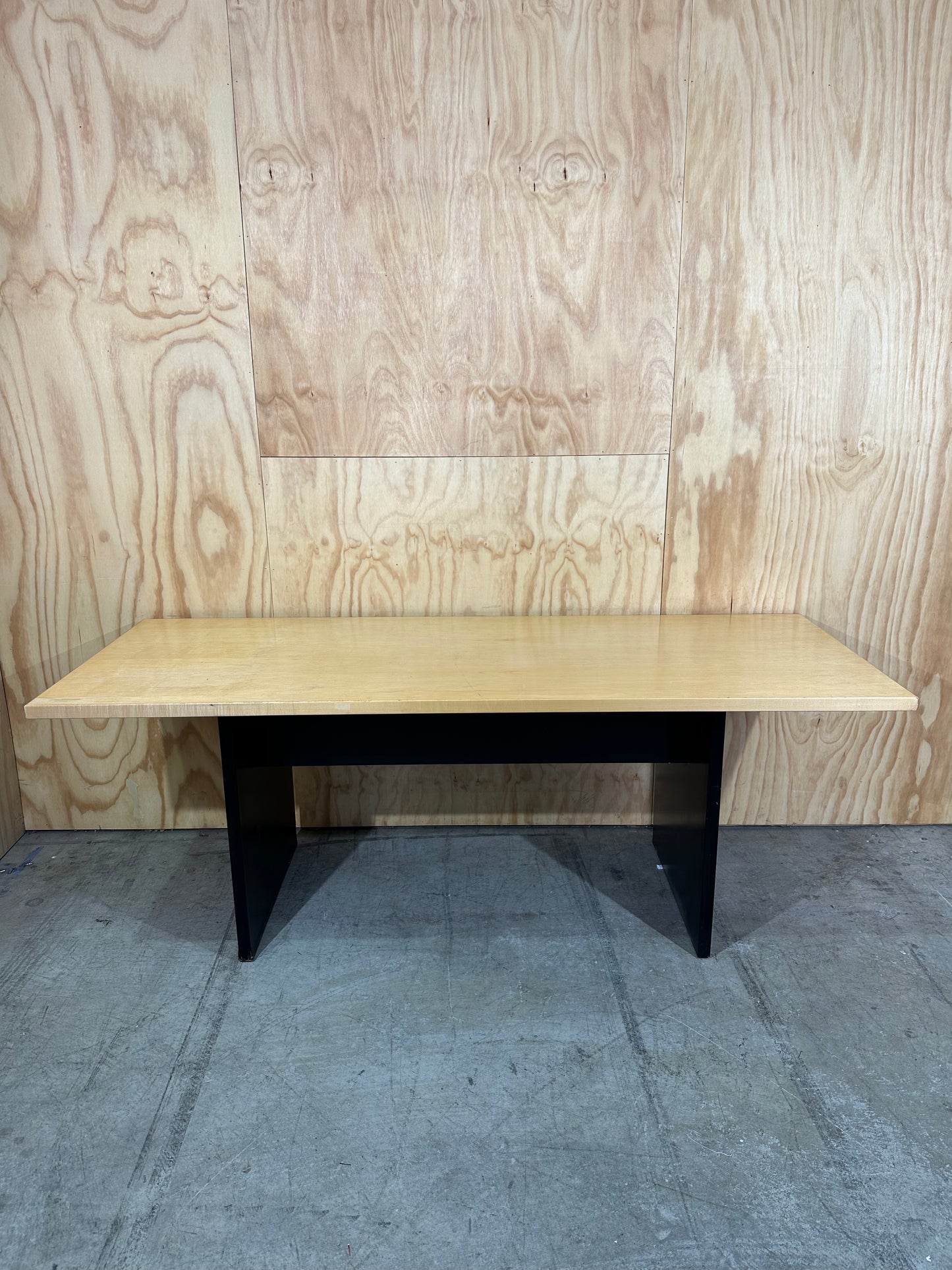 Rectangular meeting table on solid black base