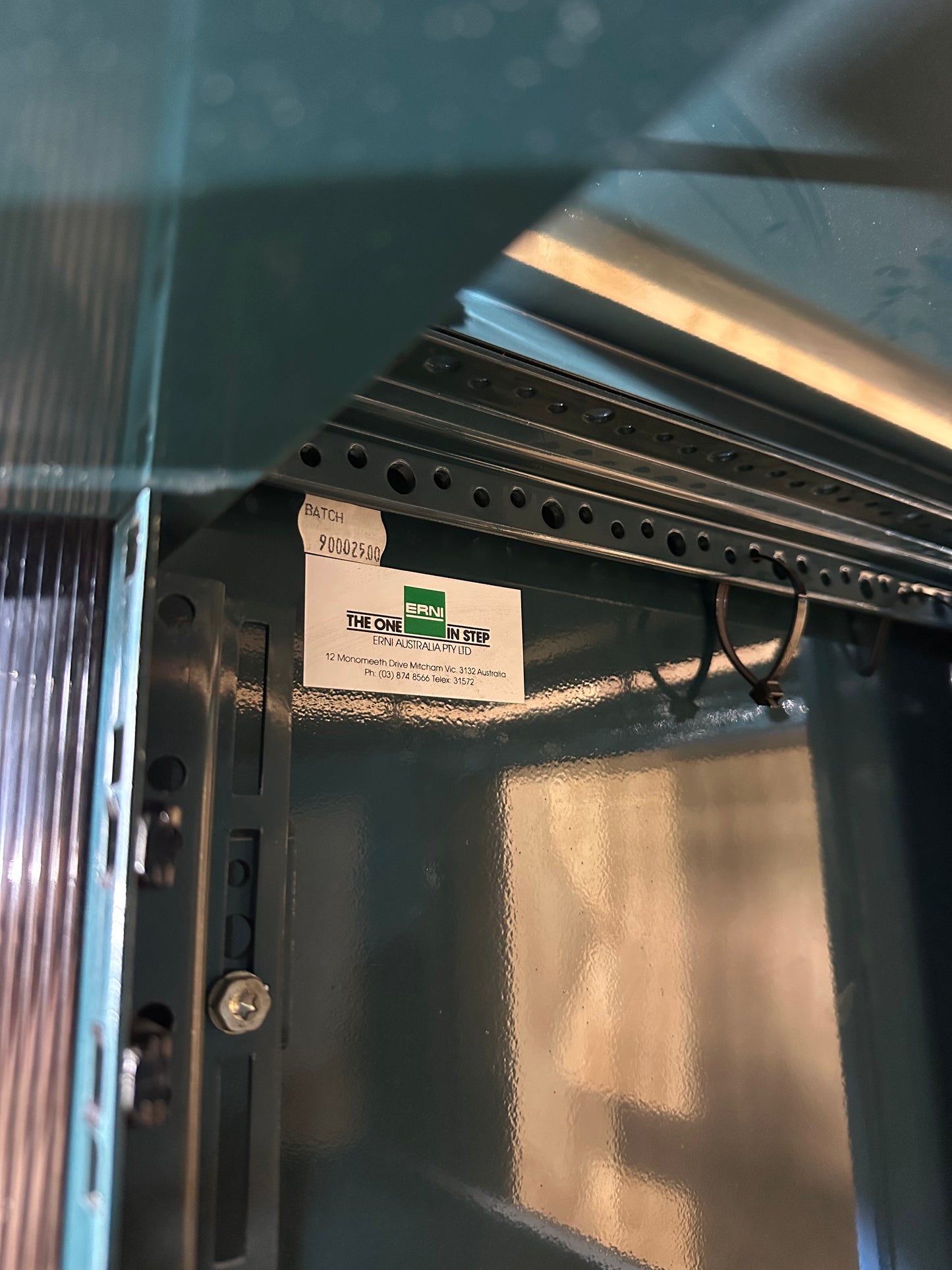 Tall dark green server cabinet with glass doors