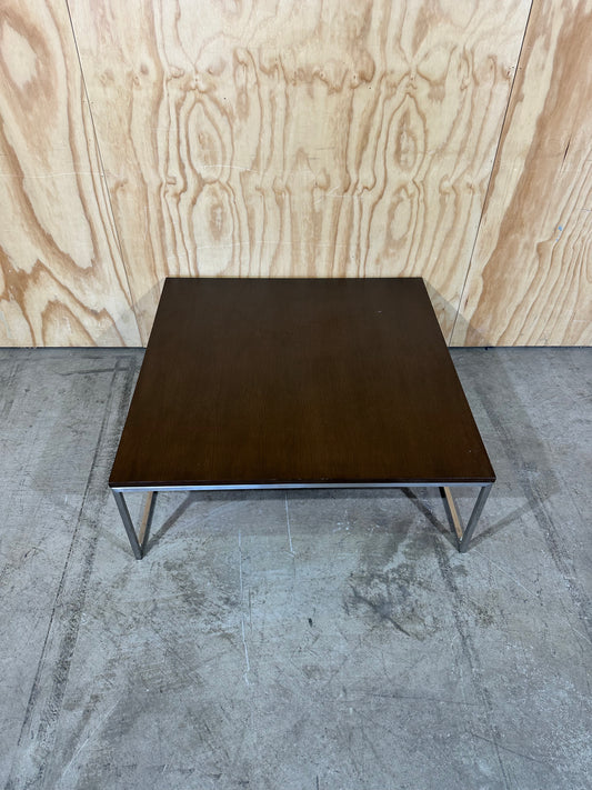 Square wood veneer coffee table on chrome base by Amart