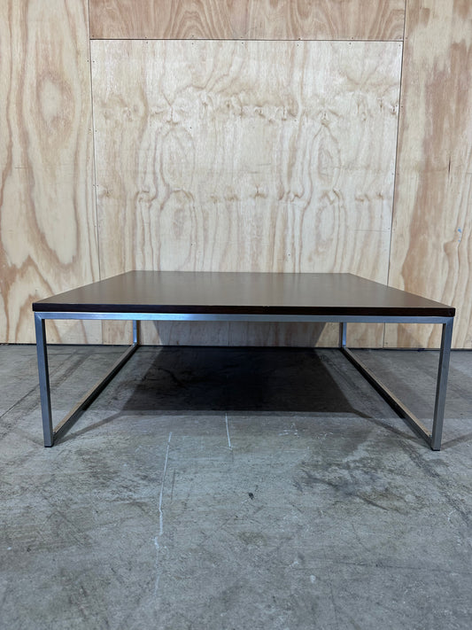 Square wood veneer coffee table on chrome base by Amart