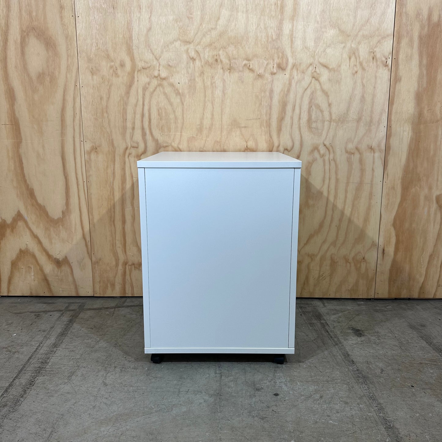 White pedestal with chrome handles on wheels