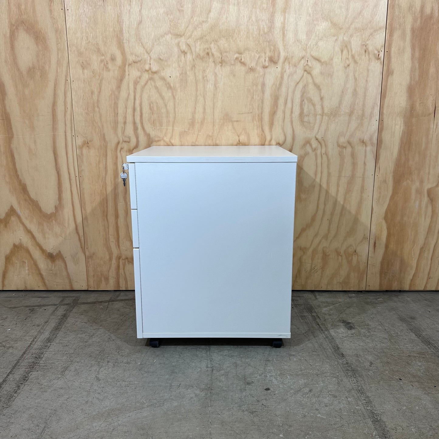 White pedestal with chrome handles on wheels