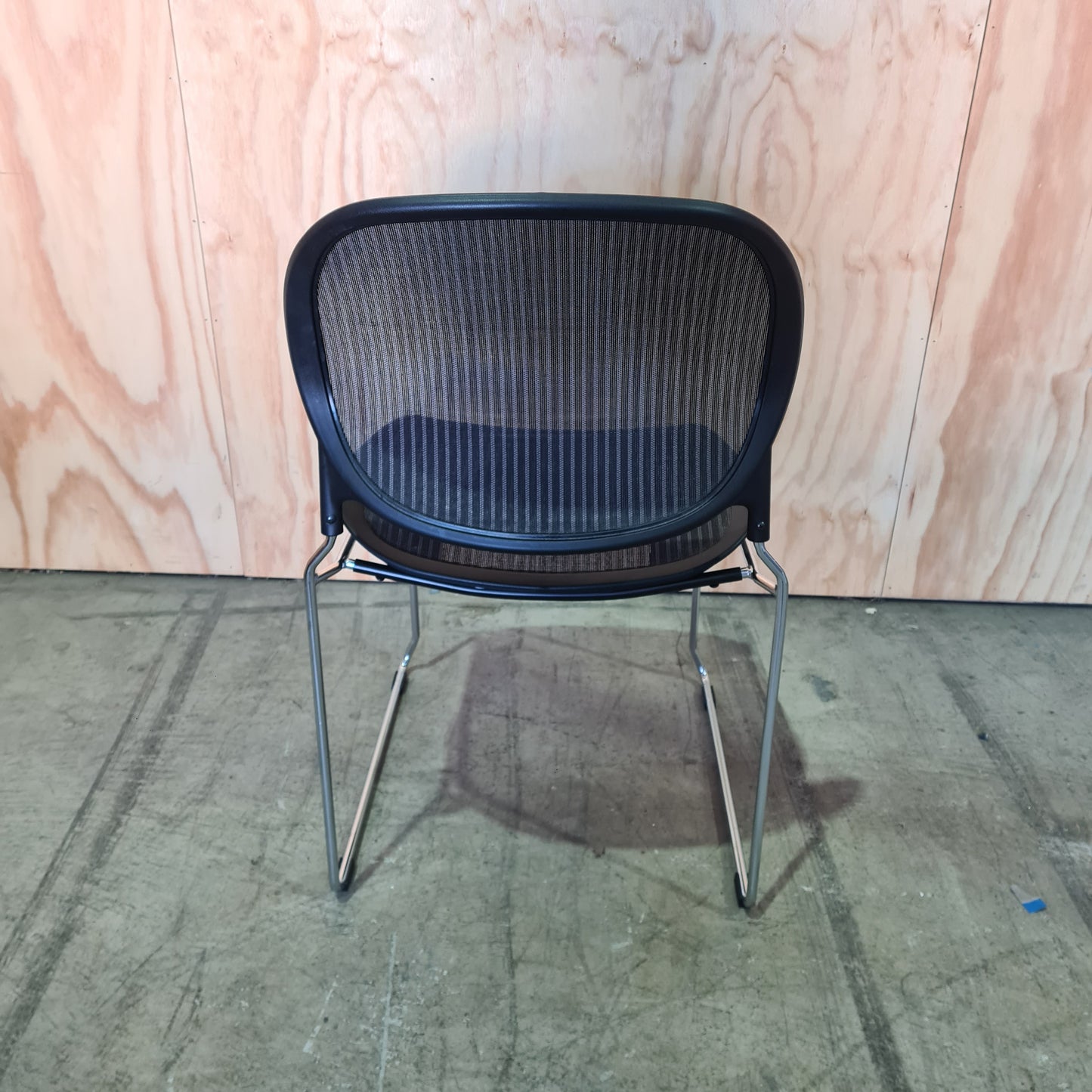 Black stacking chair with mesh back