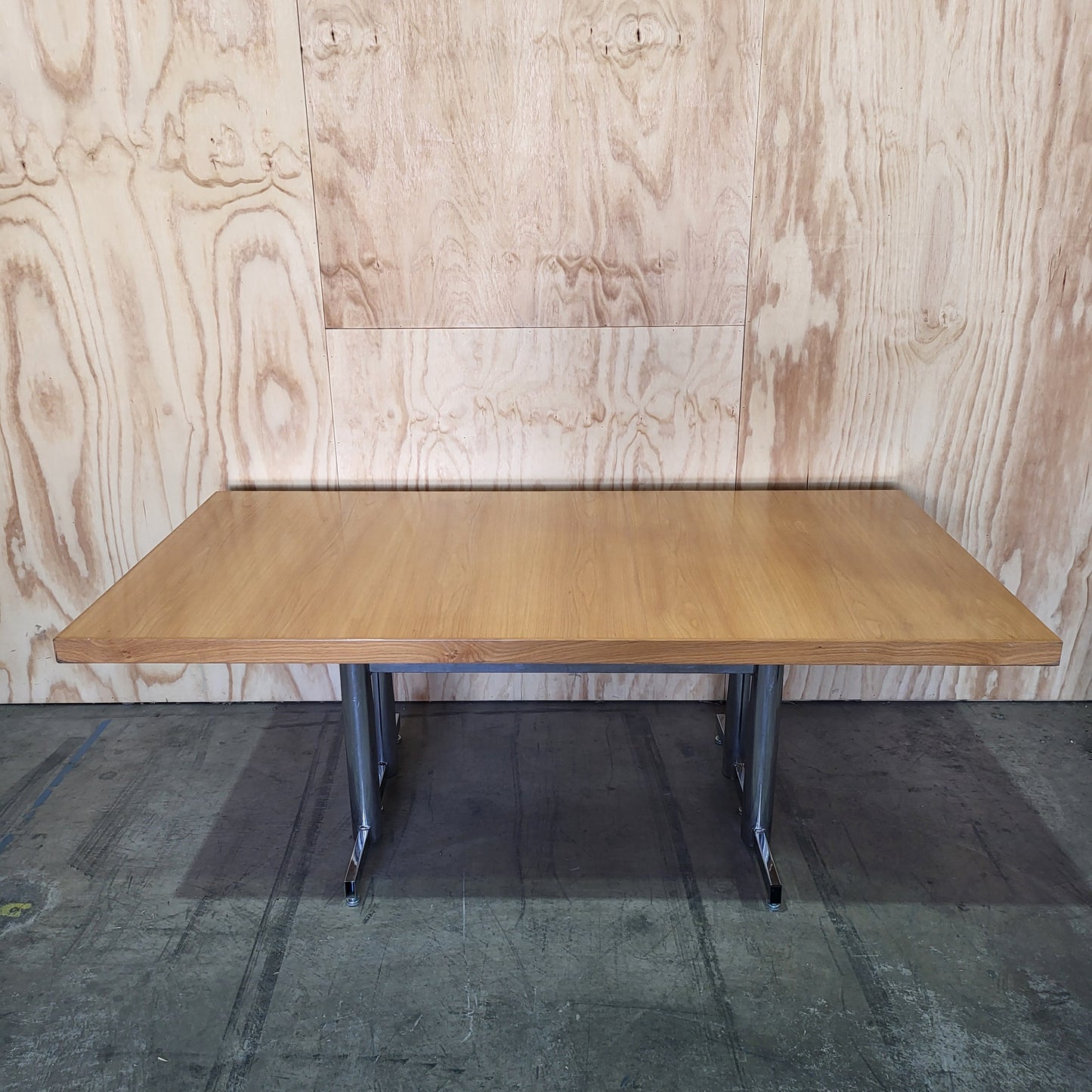 Timber veneer meeting table on chrome steel legs
