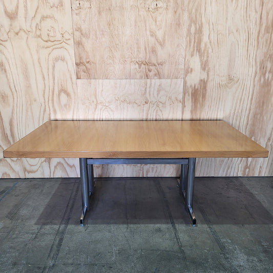 Timber veneer meeting table on chrome steel legs