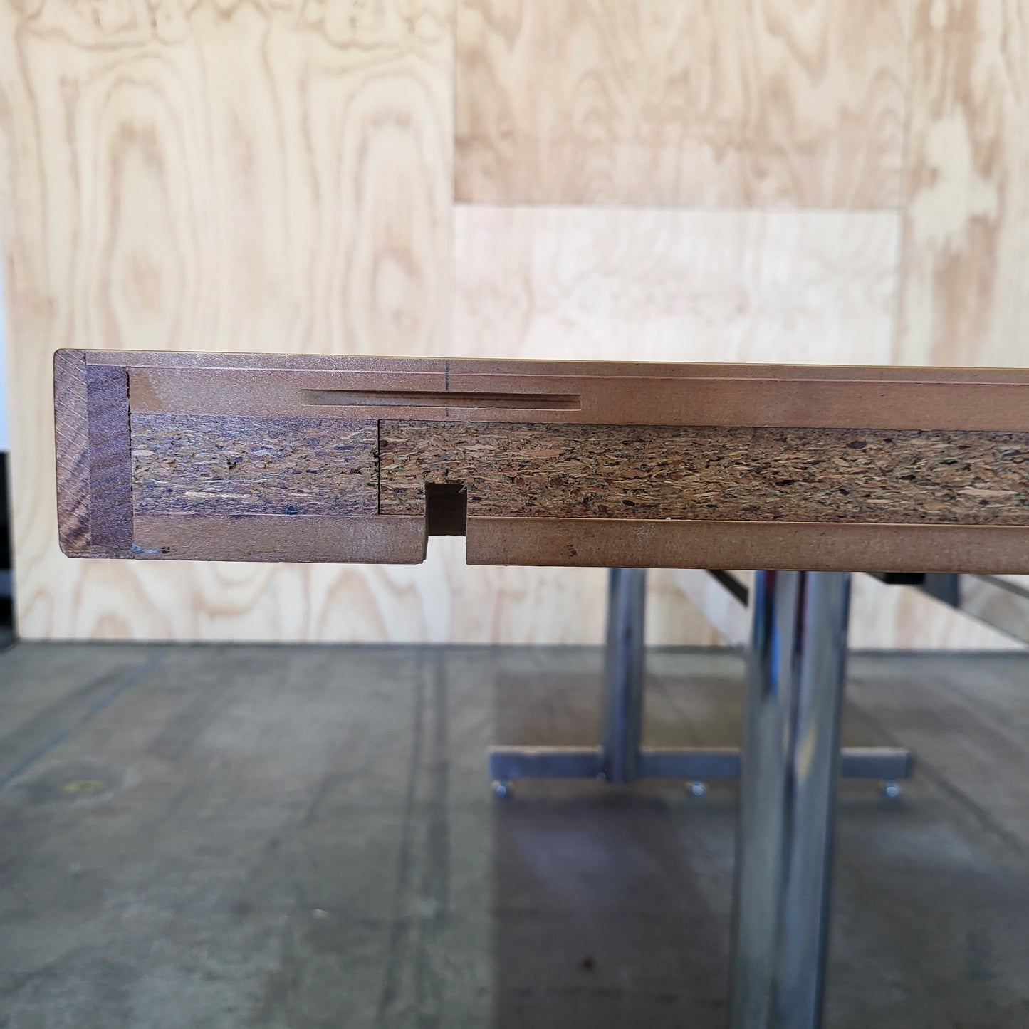 Timber veneer meeting table on chrome steel legs