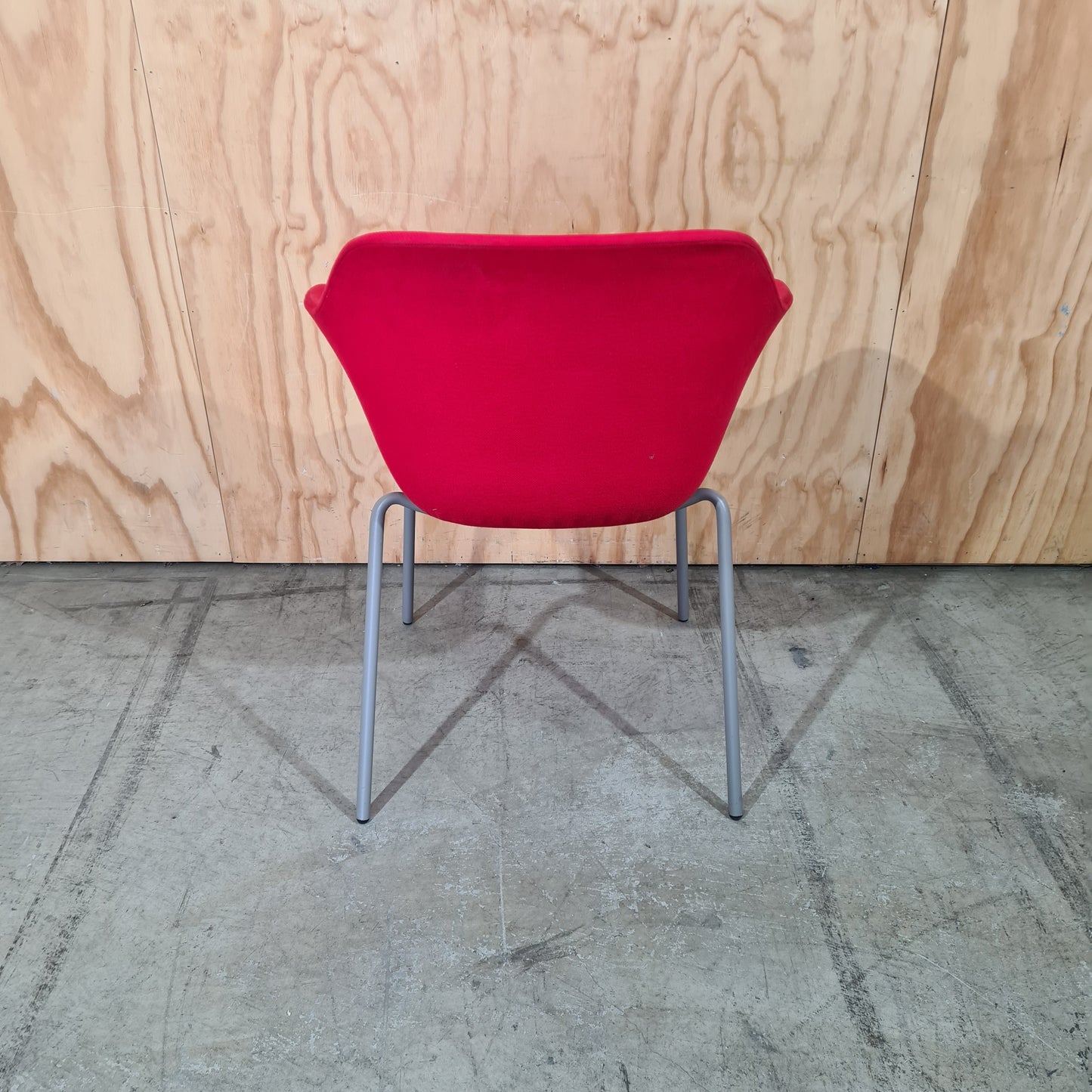 Red tub chair on grey metal legs