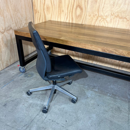 Timber table on black metal frame with castors