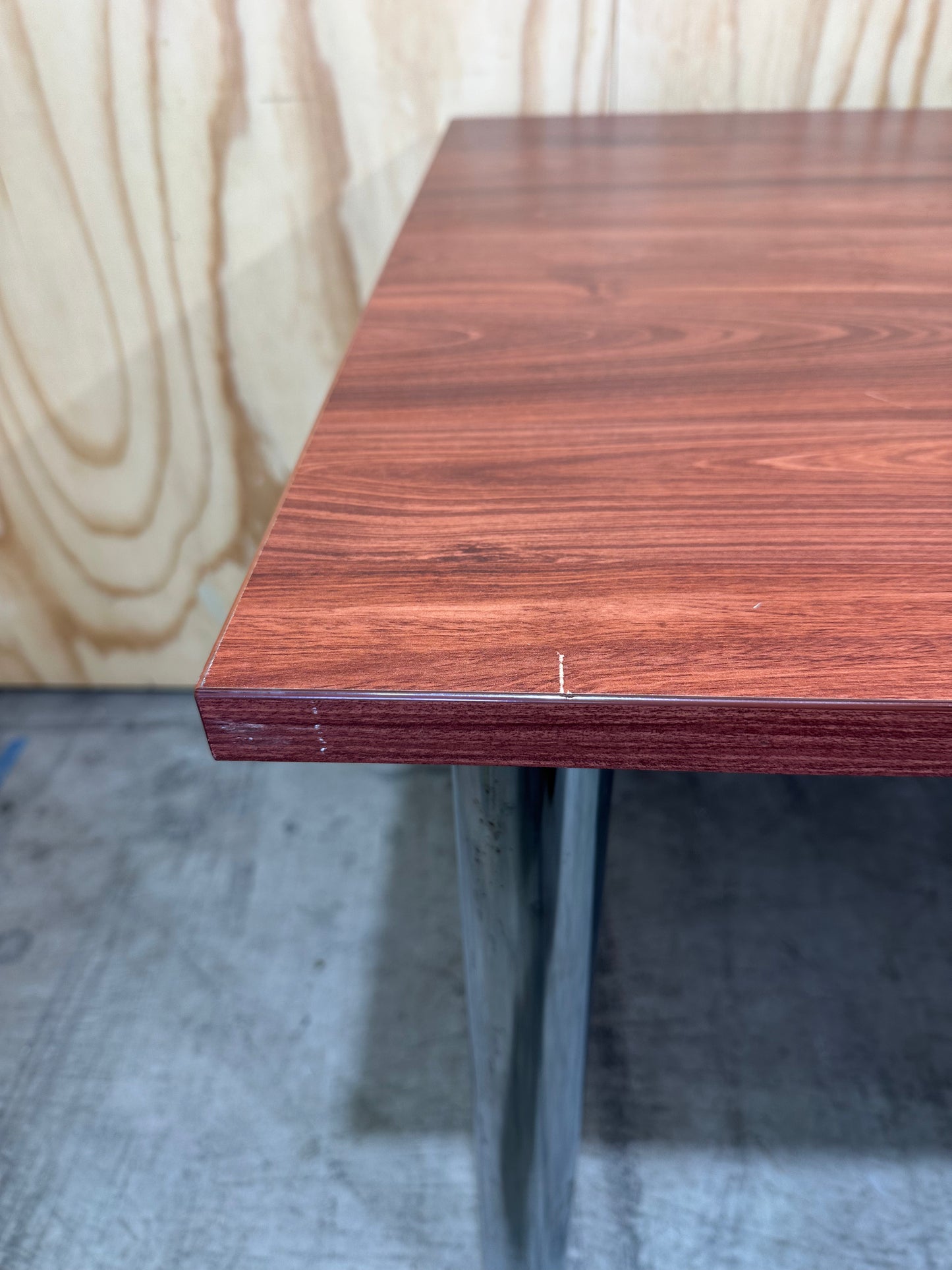 Timber veneered meeting table on chrome legs
