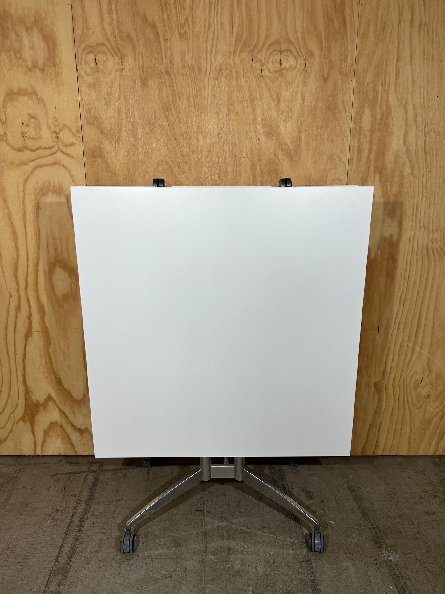 White folding table on castors