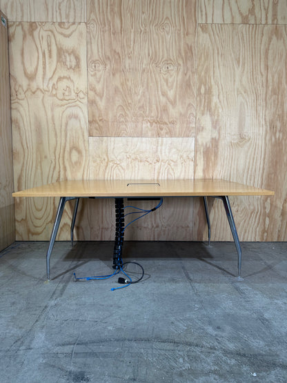 Wide wooden meeting table with cable management on chrome legs