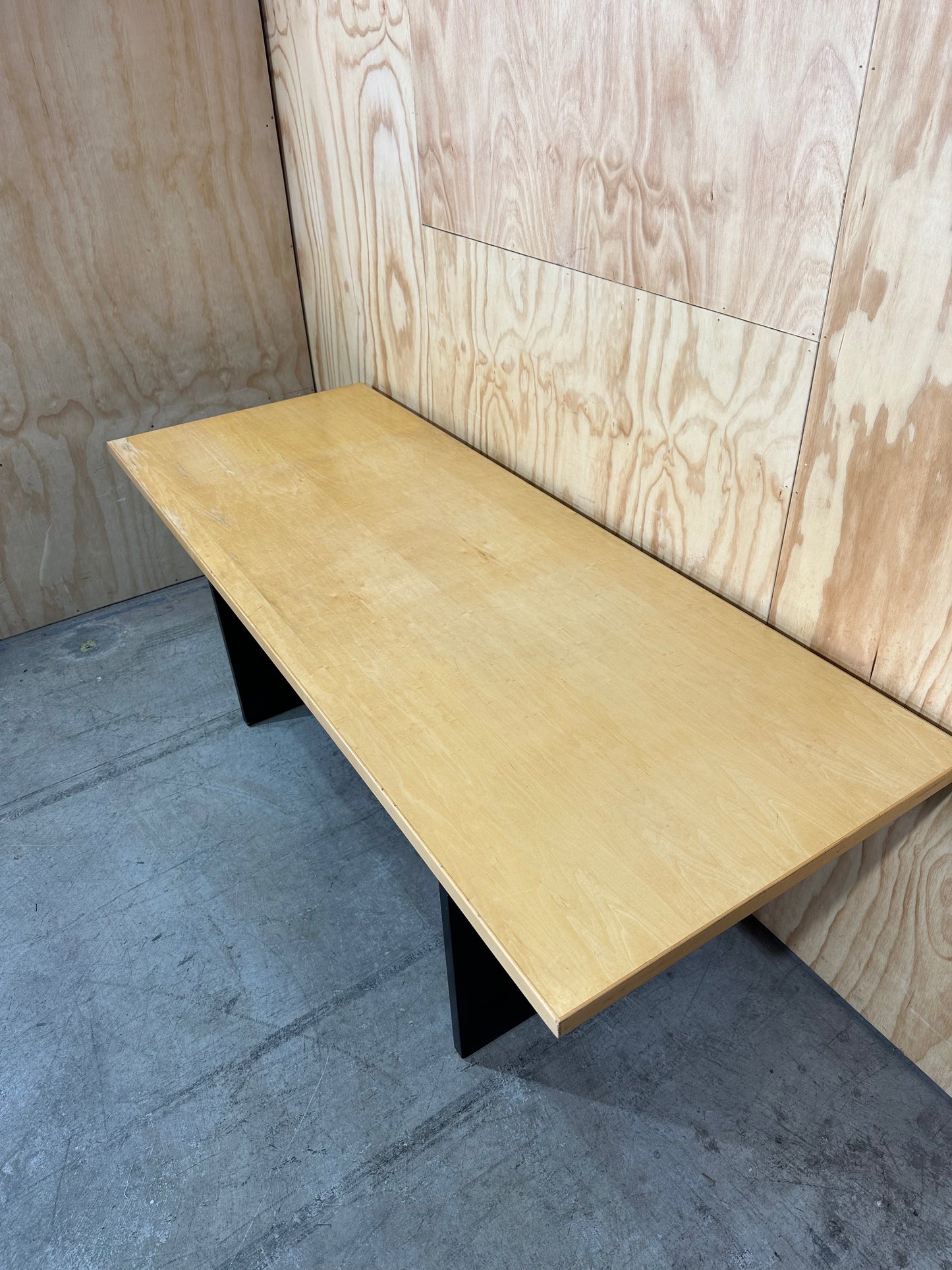 Rectangular meeting table on solid black base