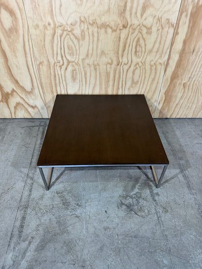 Square wood veneer coffee table on chrome base by Amart
