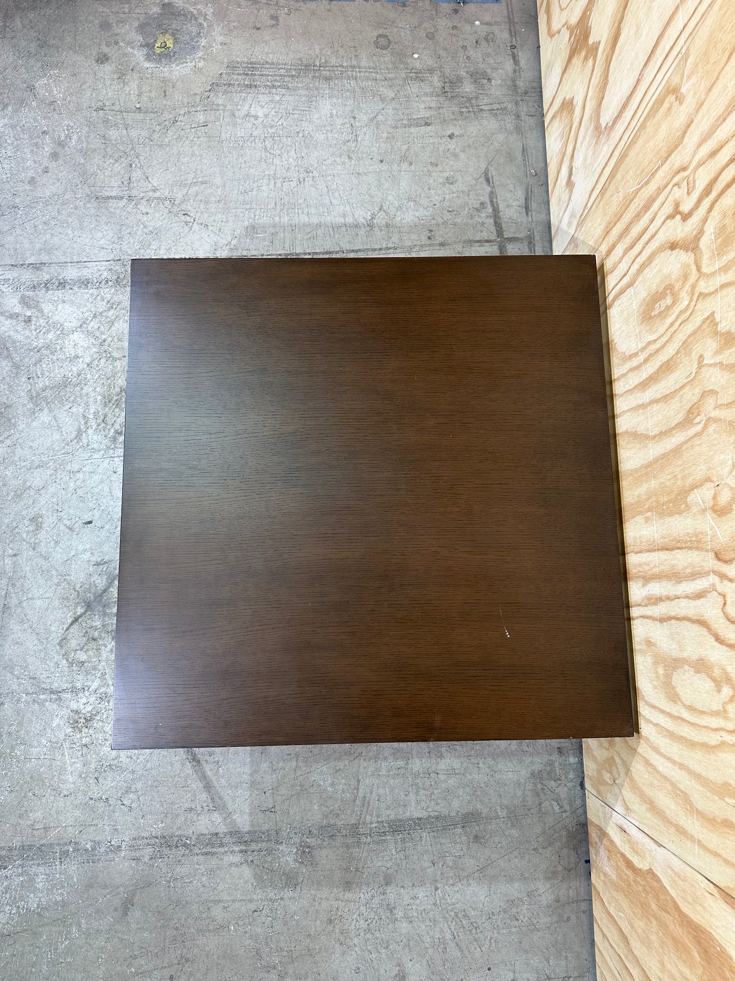 Square wood veneer coffee table on chrome base by Amart