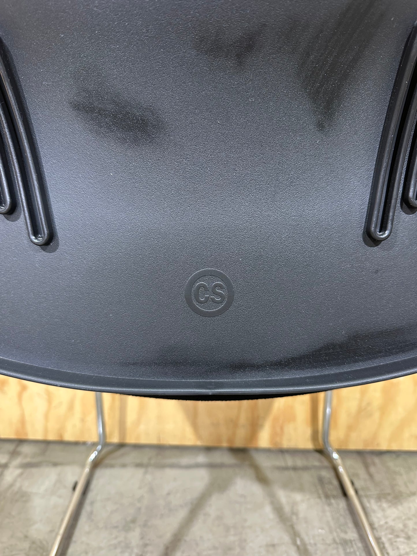 Set of 11 black stackable cushioned chairs with trolley