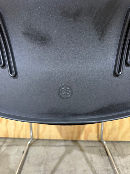 Set of 11 black stackable cushioned chairs with trolley