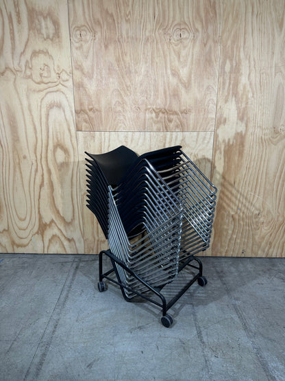 Set of 11 black stackable cushioned chairs with trolley