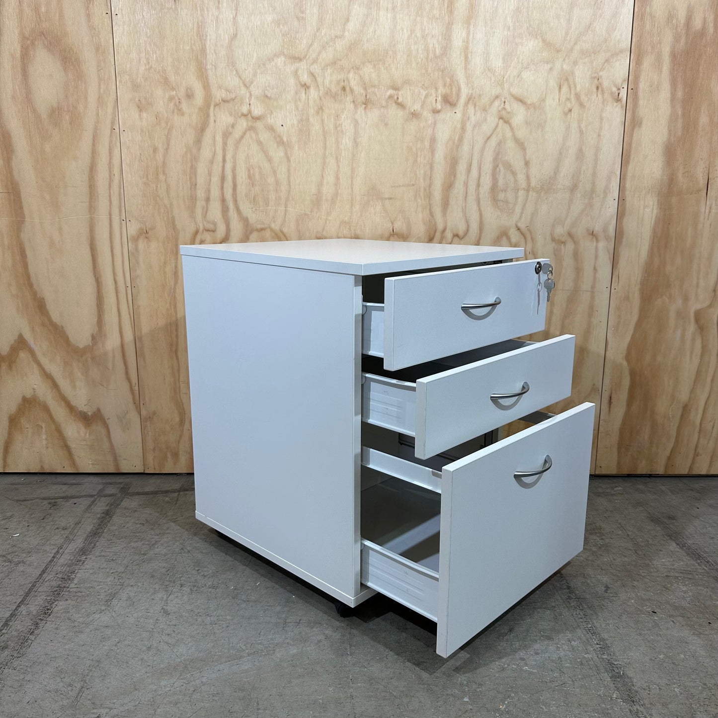 White pedestal with chrome handles on wheels