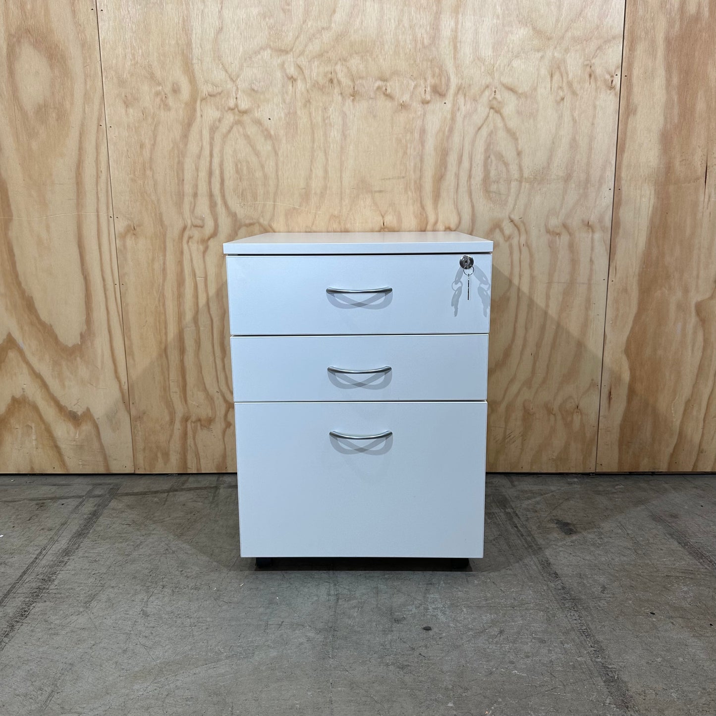 White pedestal with chrome handles on wheels