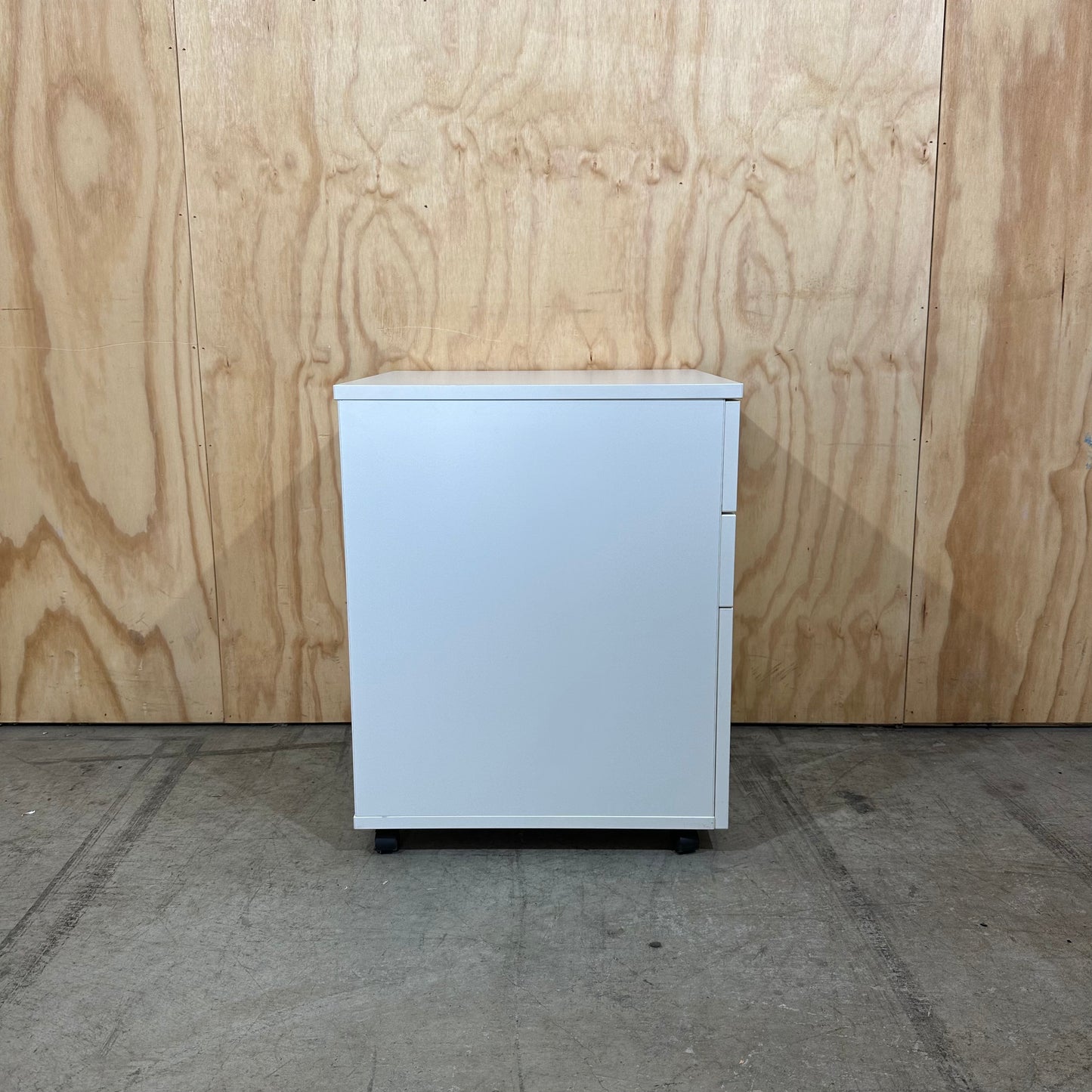 White pedestal with chrome handles on wheels