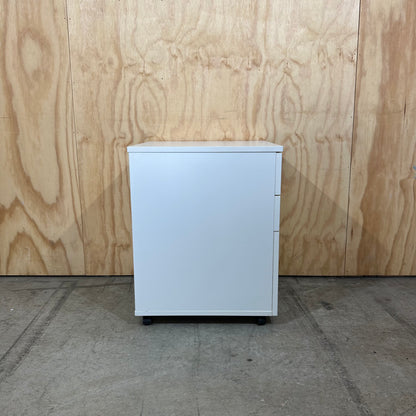 White pedestal with chrome handles on wheels