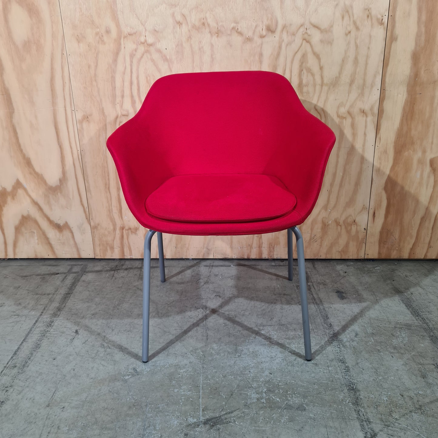 Red tub chair on grey metal legs