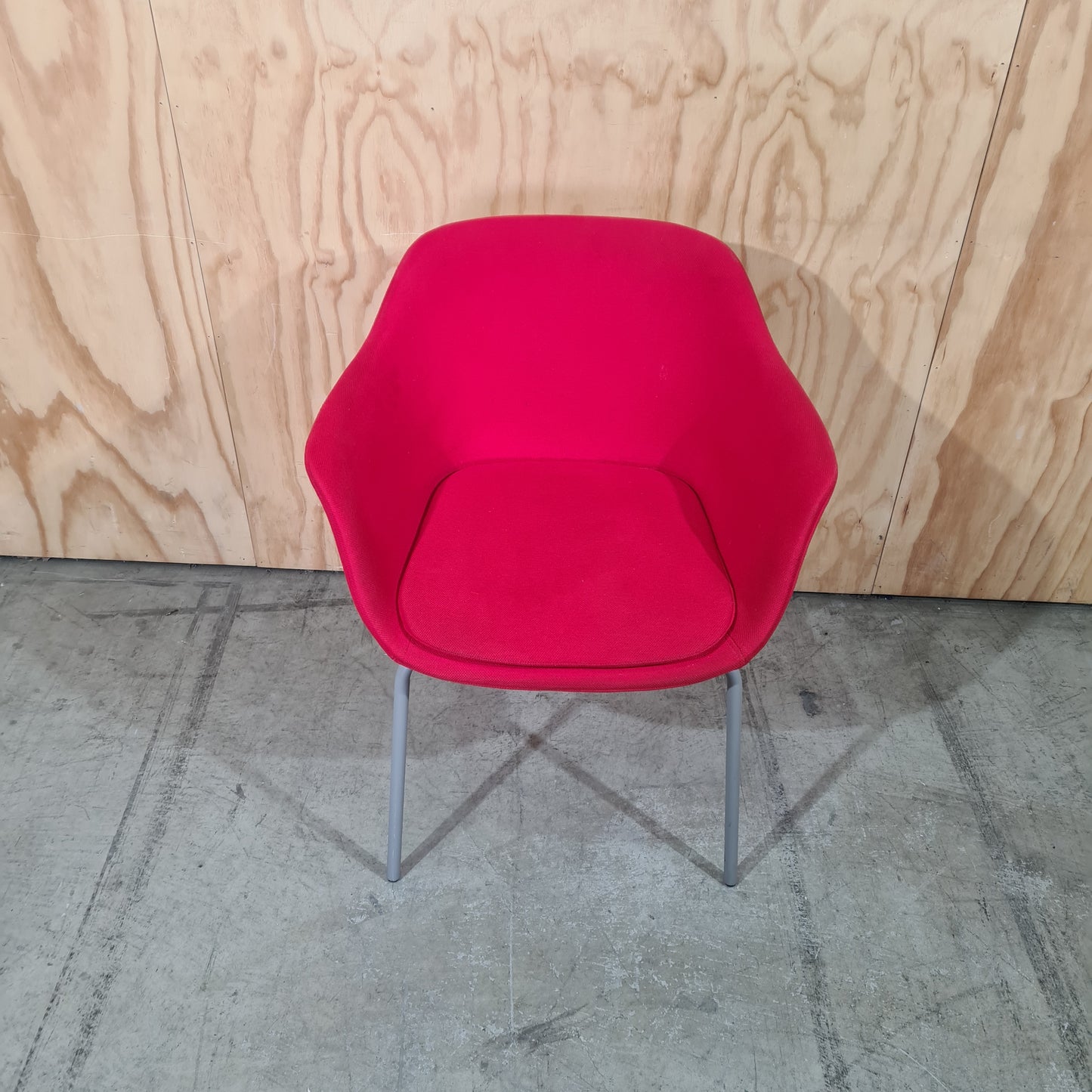 Red tub chair on grey metal legs