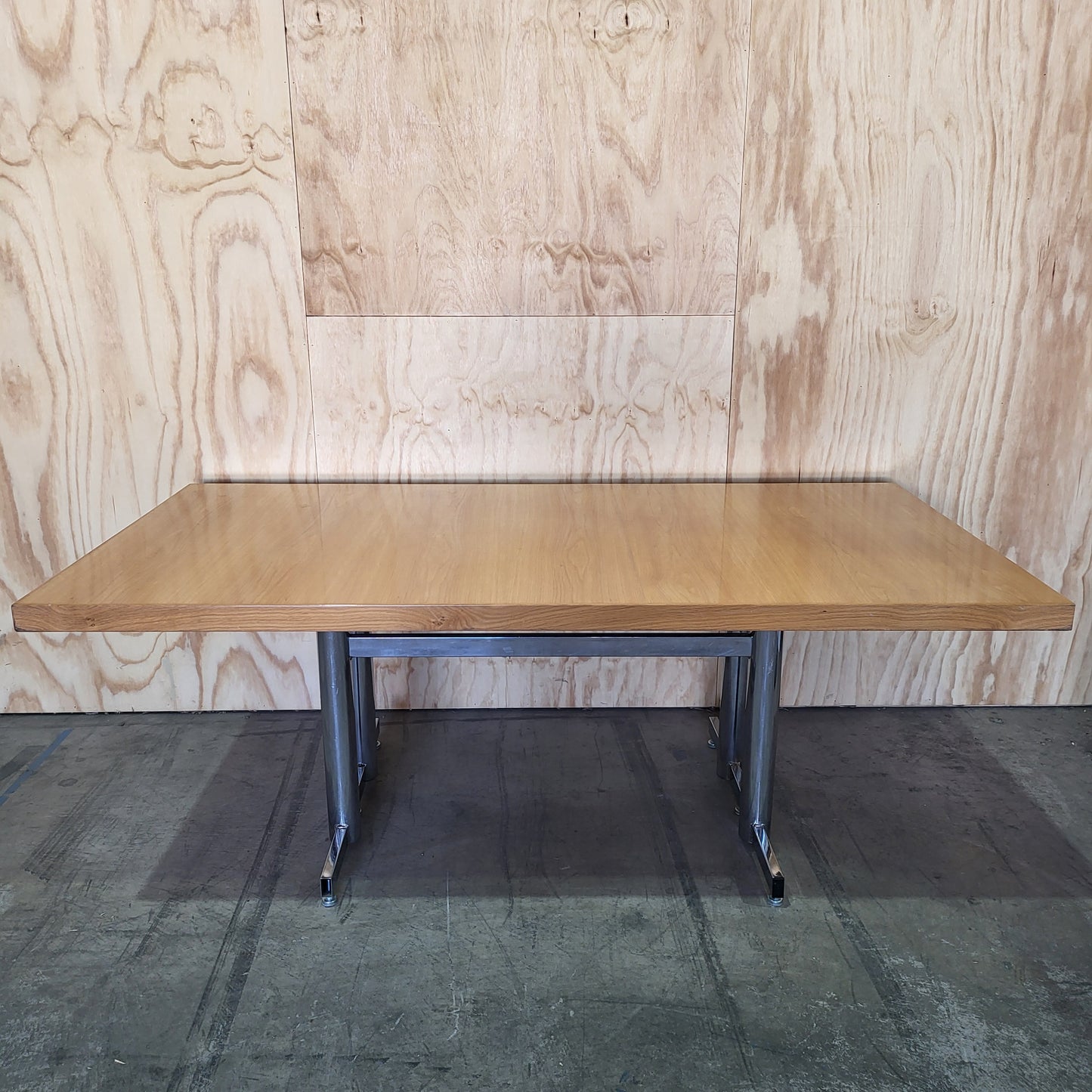 Timber veneer meeting table on chrome steel legs