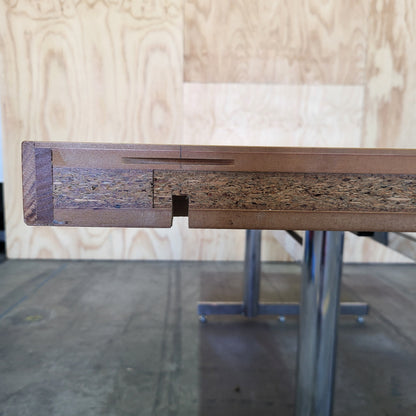 Timber veneer meeting table on chrome steel legs