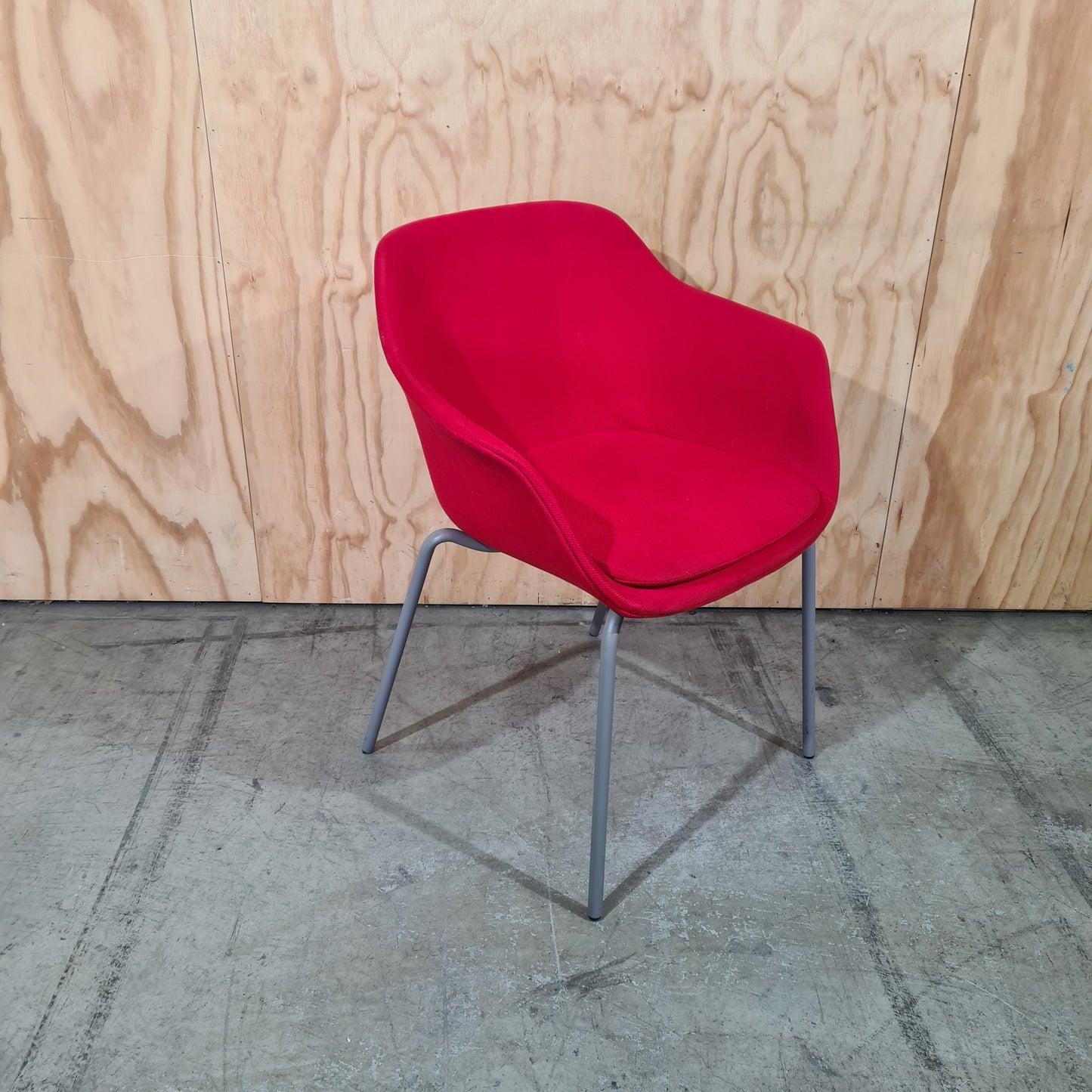 Red tub chair on grey metal legs