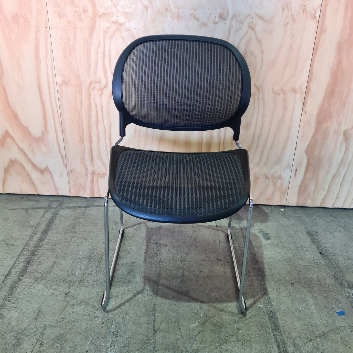 Black stacking chair with mesh back